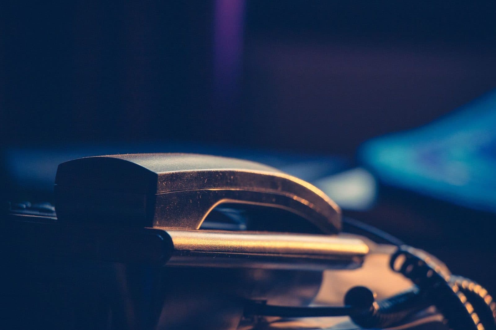 Close-up of a corded landline handset resting on its base in soft lighting